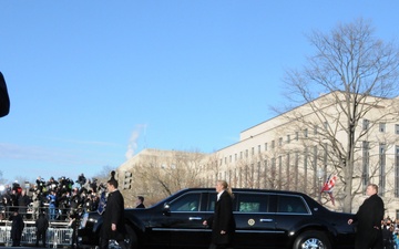 Air Force service members salute President Barack Obama as he drives by in the inaugural parade