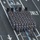 57th Presidential Inauguration An aerial view of a large military formation marching in parade formation down a multi-lane urban street. The cadets are dressed in gray dress uniforms with white cross-belts and carry rifles at shoulder arms. Several officers in dark dress uniforms flank the formation as it moves in precise alignment.