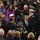 57th Presidential Inauguration A large formal outdoor gathering featuring a crowd of people in winter attire, including several individuals in military dress uniforms. The scene appears to be a significant public ceremony or official event, with a dense crowd of attendees, security personnel, and officials. Multiple military officers in formal regalia are visible among the crowd.