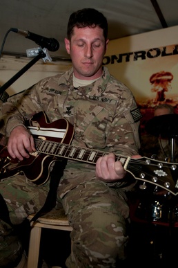 Deployed sailor starts band, amps up morale
