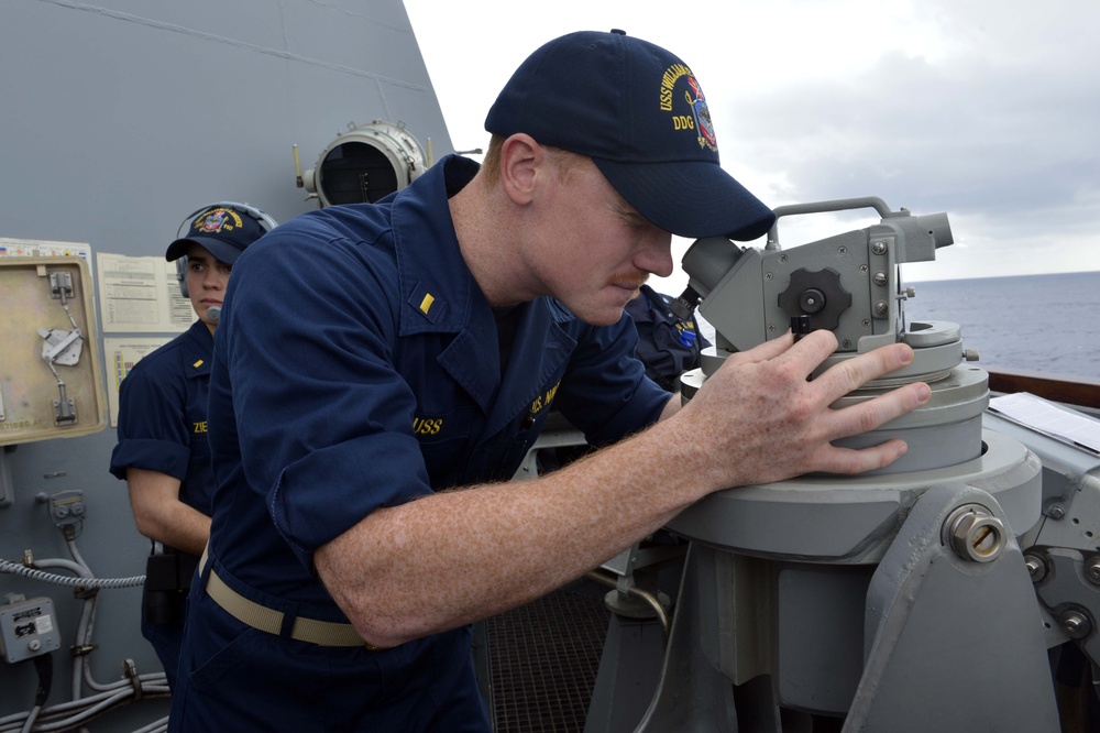 USS William P. Lawrence sailor scans the horizon