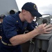 USS William P. Lawrence sailor scans the horizon