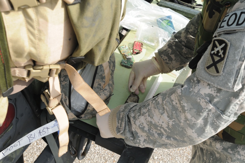 Explosive ordnance disposal specialists collect evidence during a training exercise