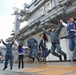 NFL cheerleaders jump with USS George Washington sailors