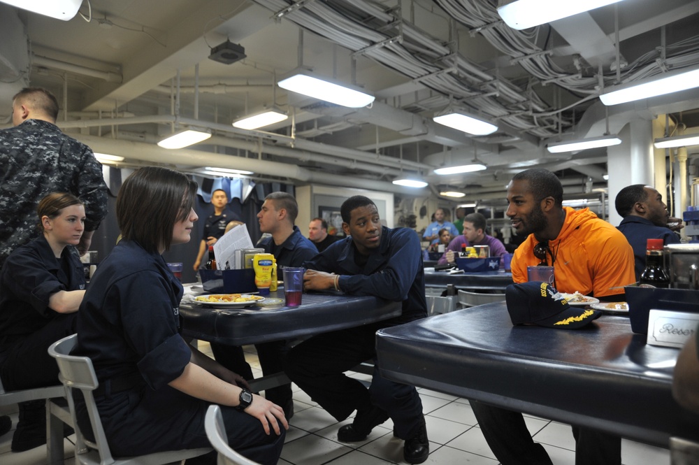 Football players meet sailors aboard USS George H.W. Bush