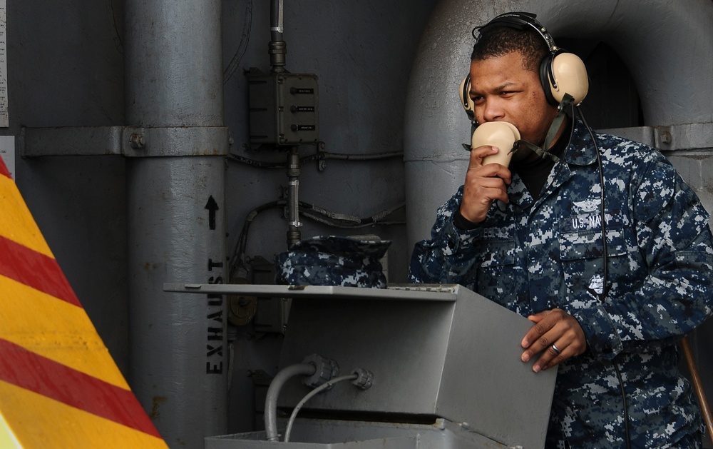 Sailor communicates aboard ship