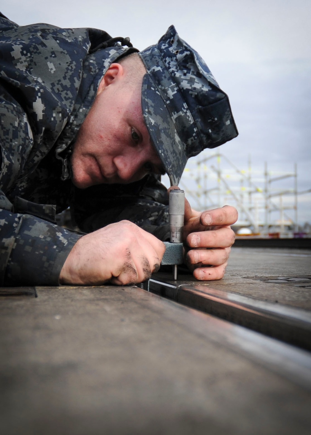 Sailor takes measurements on flight deck