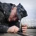 Sailor takes measurements on flight deck