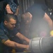 Sailors replace gasket on fuel pipe