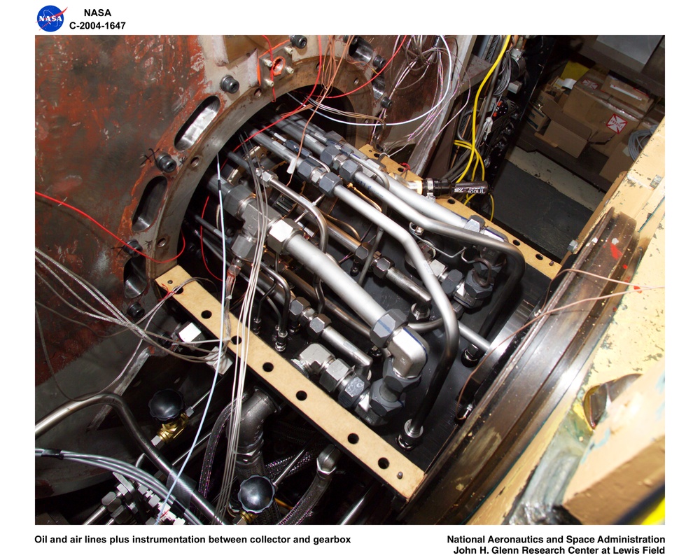 Ultra-Efficient Engine Technology  (UEET), Proof of Concept Compressor, Advanced Compressor Casing Treatment testing; close up - throttle valve -wide open; oil and air lines plus instrumentation between collector and gearbox.