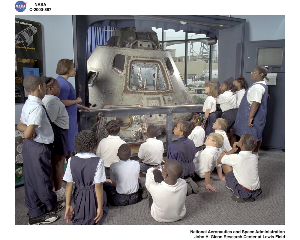 AERONAUTICS GALLERY IN VISITOR INFORMATION CENTER AND CHILDREN AT APOLLO CAPSULE DISPLAY AND CHILD WEARING APOLLO SPACE SUIT