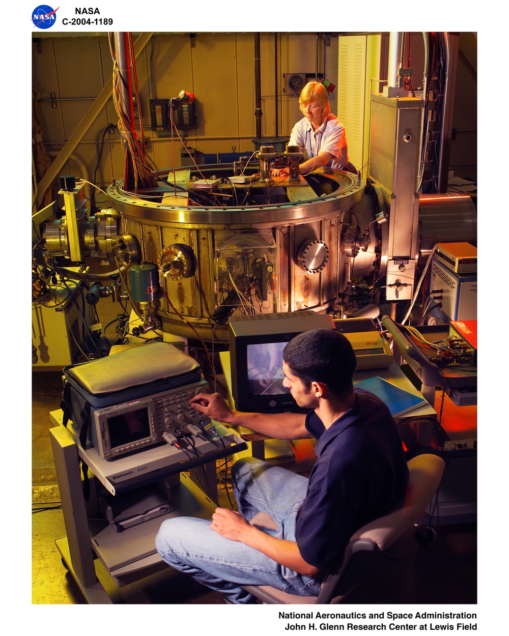 Researchers make hardware adjustments to and verify instrument functions for the PPT for the CIPT life test. (Pulsed Plasma Thruster)    (Contractor Integrated Product Team)