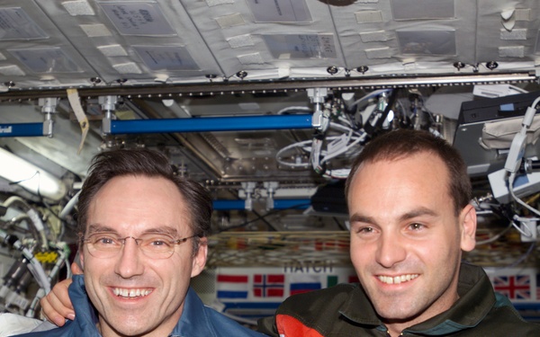 Walz and Shuttleworth pose for a photo in U.S. Lab during Expedition Four