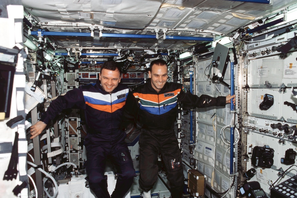 Gidzenko and Shuttleworth pose for a photo in the U.S. Laboratory during Expedition Four