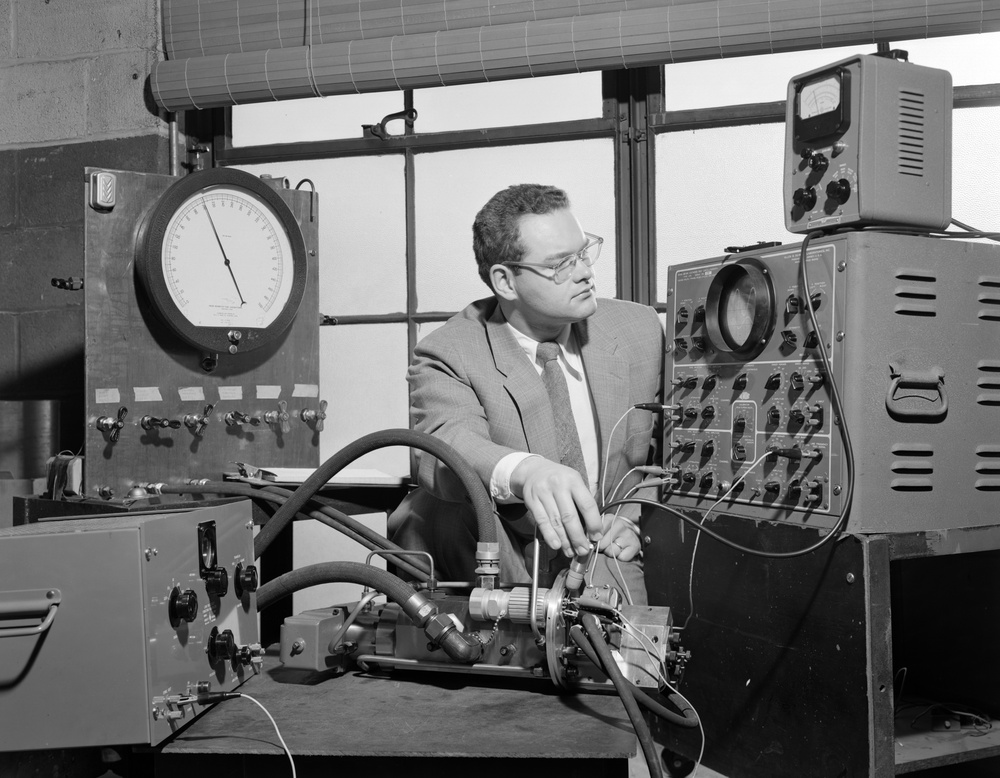 ENGINEER WORKING OUT FUEL SYSTEM CONTROL PROBLEM ON HYDRAULIC VALVE ACTUATOR FOR USE IN RECRUITING BROCHURE