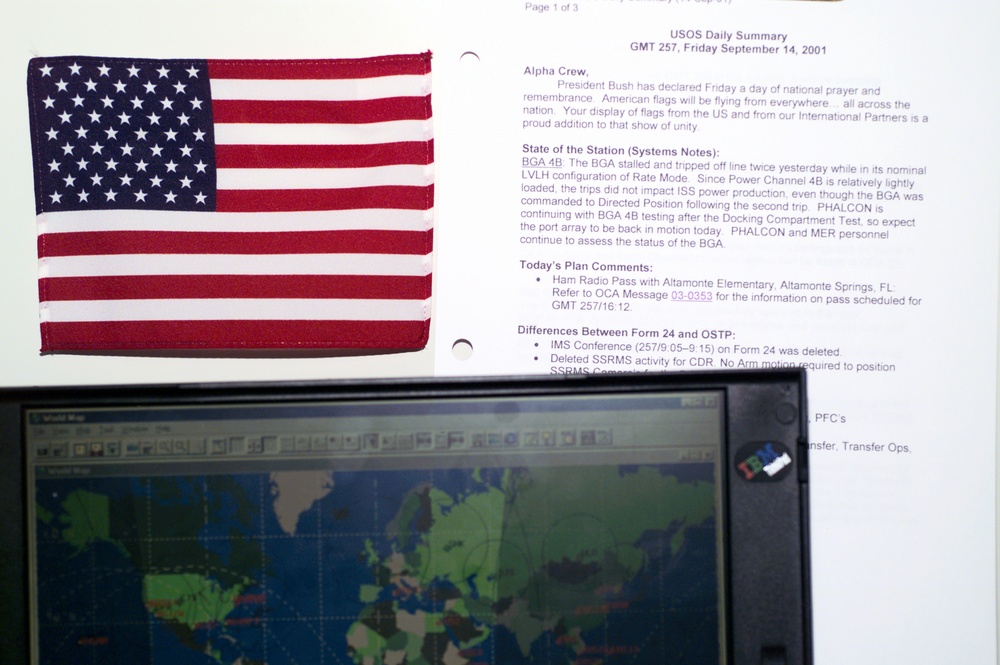 View of an American flag and computer in the U.S. Laboratory during Expedition Three