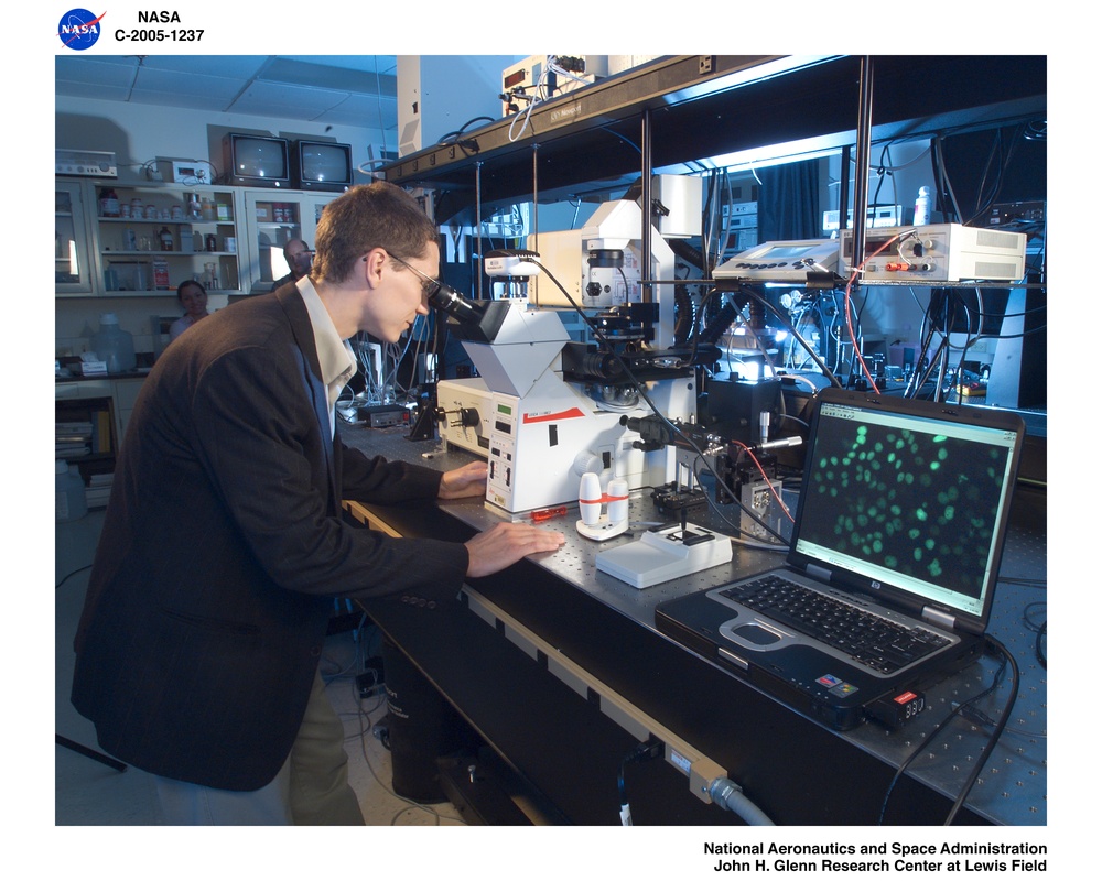 Researchers using microscope in the Biophotonics Laboratory