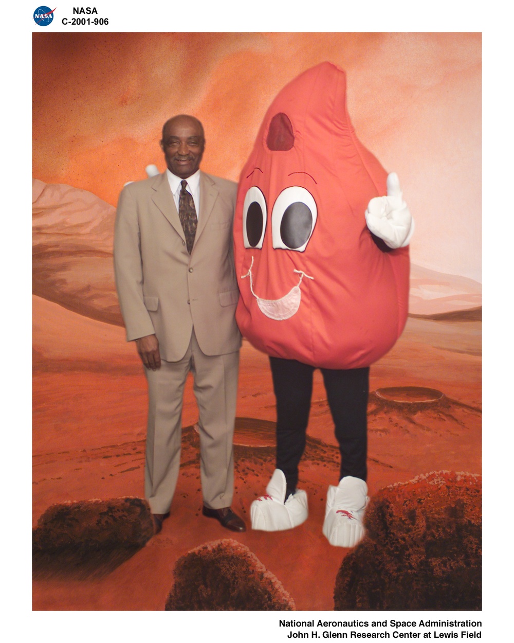 CENTER DIRECTOR DONALD CAMPBELL WITH BUDDY BLOOD DROP - THE AMERICAN RED CROSS BLODD DONATION MASCOT