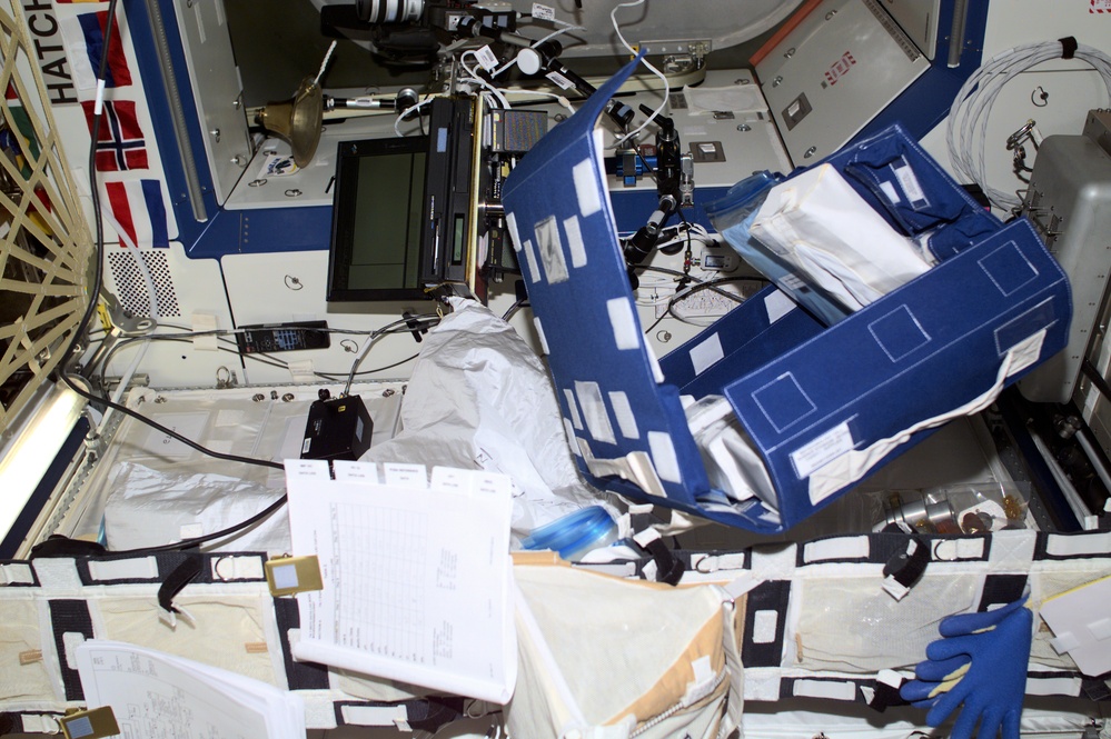 View of a laptop and documents in Destiny taken during Expedition Three