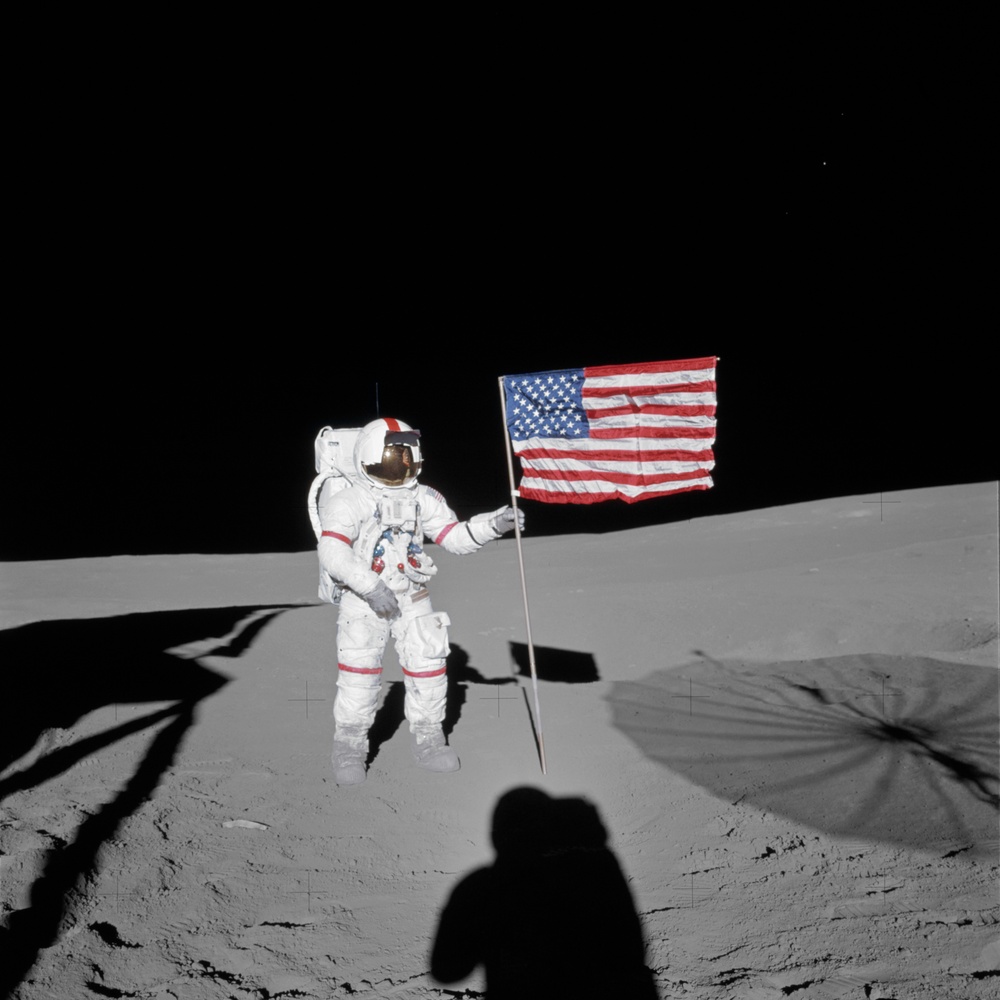 Apollo 14 Mission image - Astronaut Alan B. Shepard, Jr., commander of the Apollo 14 lunar landing mission, stands by the deployed United States flag on the lunar surface during the early moments of the first Extravehicular Activity EVA-1 of the mission.