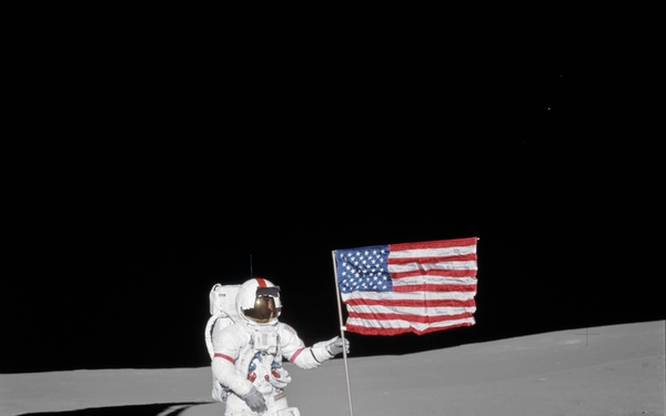 Apollo 14 Mission image - Astronaut Alan B. Shepard, Jr., commander of the Apollo 14 lunar landing mission, stands by the deployed United States flag on the lunar surface during the early moments of the first Extravehicular Activity EVA-1 of the mission.
