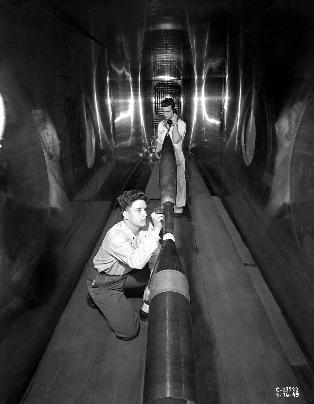 RM-10 INSTALLATION IN THE 8X6 FOOT WIND TUNNEL - OPERATIONS ENGINEER RAYMOND J KARABINUS AND TECHNICIAN GRADY S SPEER MAKE FINAL CHECK OF BOUNDARY LAYER RAKES AT READ OF STING MOUNTED LANGLEY RESEARCH MISSILE MODEL BEFORE TESTS IN THE 8X6 FOOT WIND