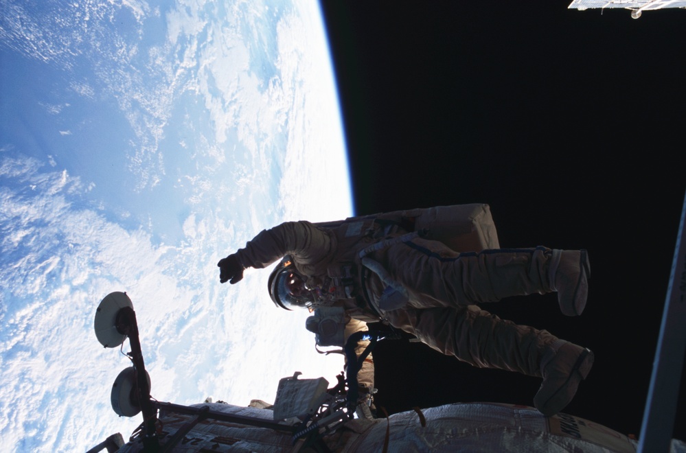 Bursch waves for camera during Expedition Four EVA 2