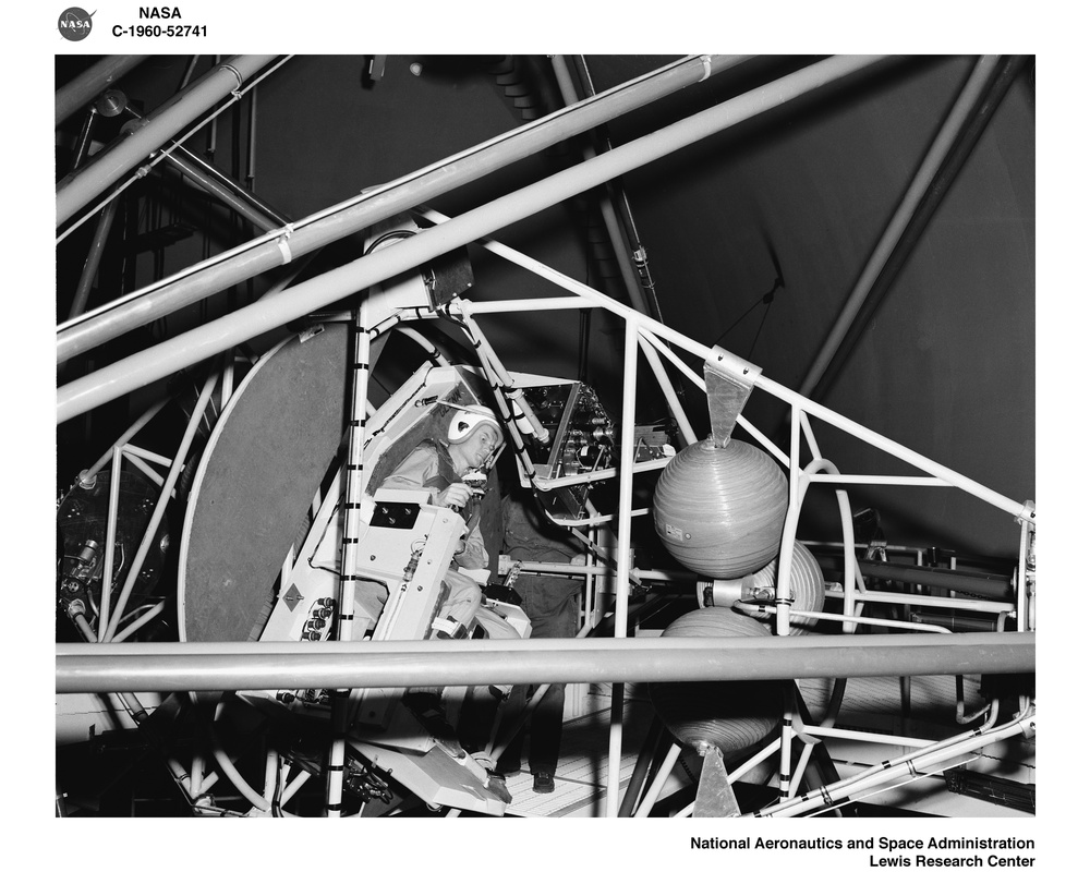PROJECT MERCURY - ASTRONAUT JOHN H GLENN JUNIOR TESTING THE GIMBALING RIG IN THE ALTITUDE WIND TUNNEL AWT AT NASA LEWIS RESEARCH CENTER