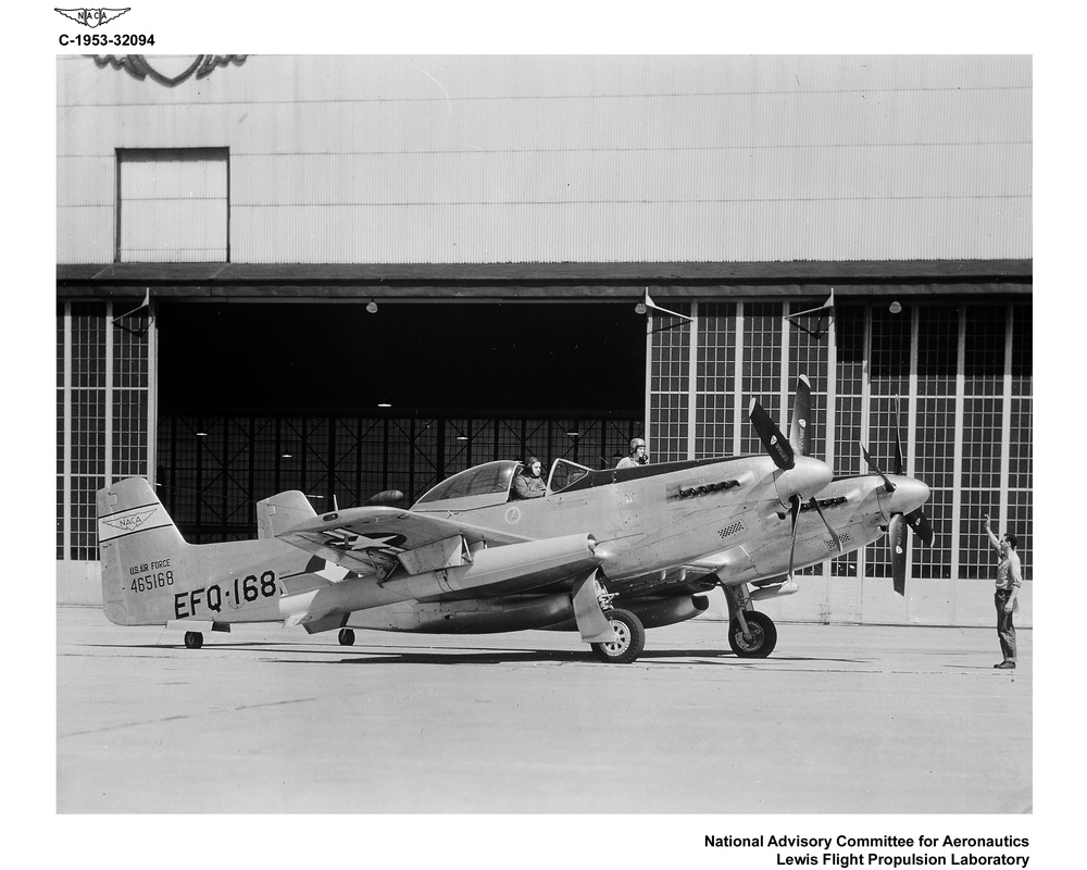 F-82 AIRPLANE ON HANGAR APRON WITH GUIDED MISSILE UNDER WING BEFORE FLIGHT