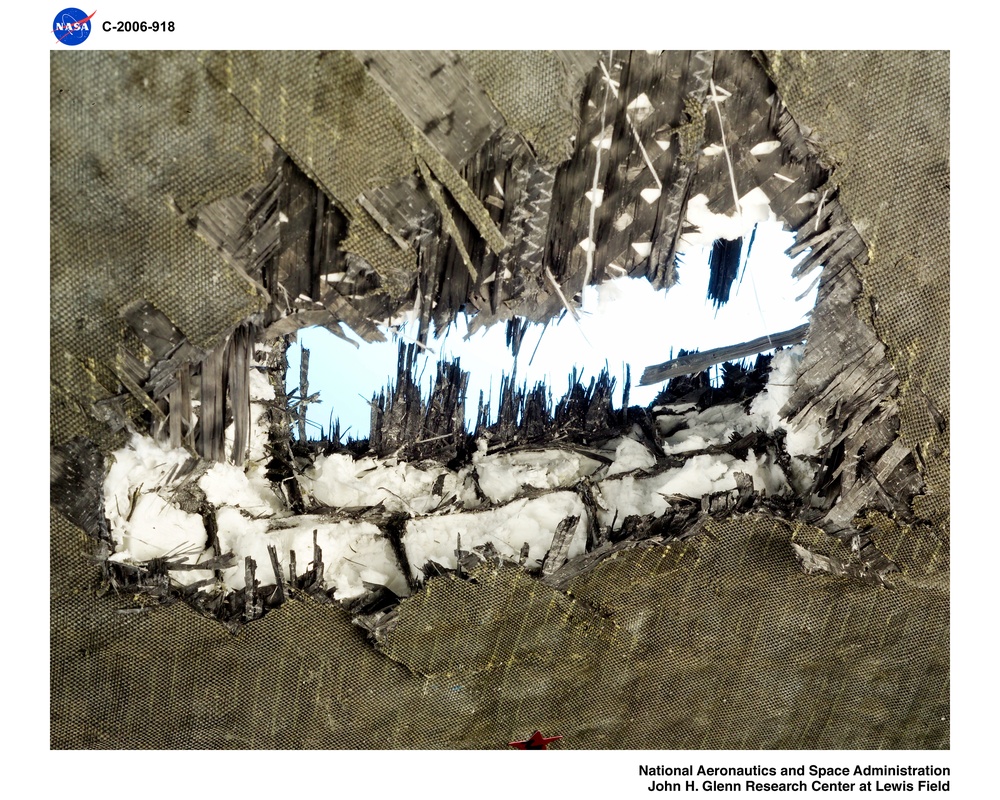 Fan Containment Ring with instrumentation.  Post test photos showing ballistic impact testing results