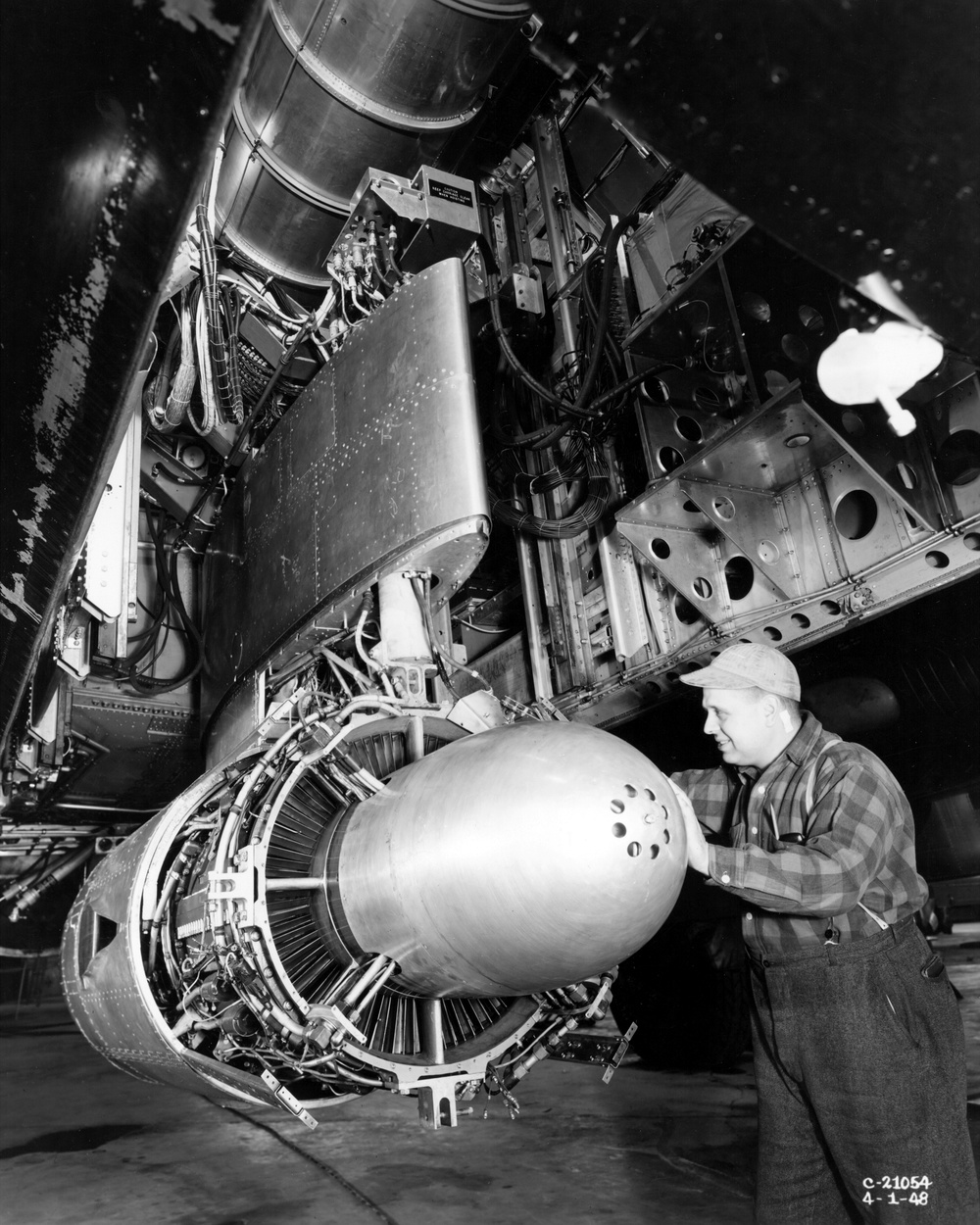 TG-180 ENGINE IN B-29 AIRPLANE IN PROCESS OF DISASSEMBLY