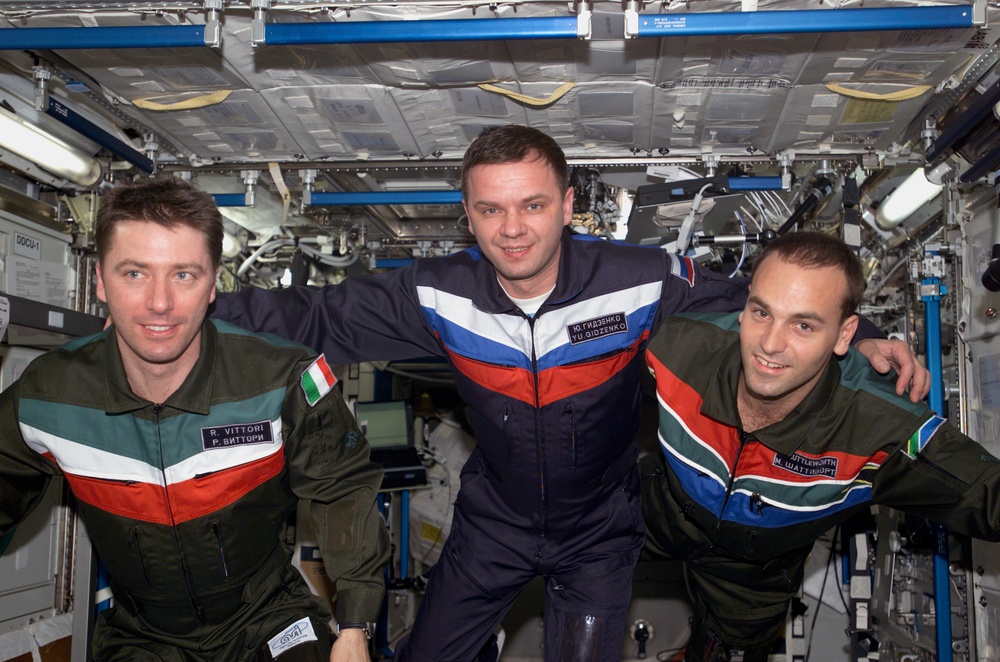 Soyuz 4 taxi-3 flight crew poses for group photo in U.S. Lab during Expedition Four