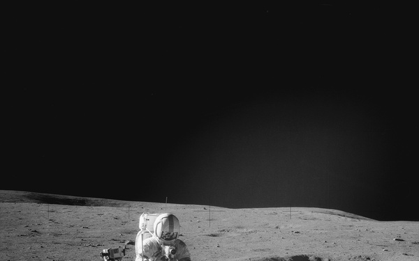 Apollo 14 Mission image - Astronaut Alan B. Shepard Jr., Apollo 14 commander, assembles a double core tube as he stands beside the rickshaw-type portable workbench or Modularized Equipment Transporter MET unique to this mission.