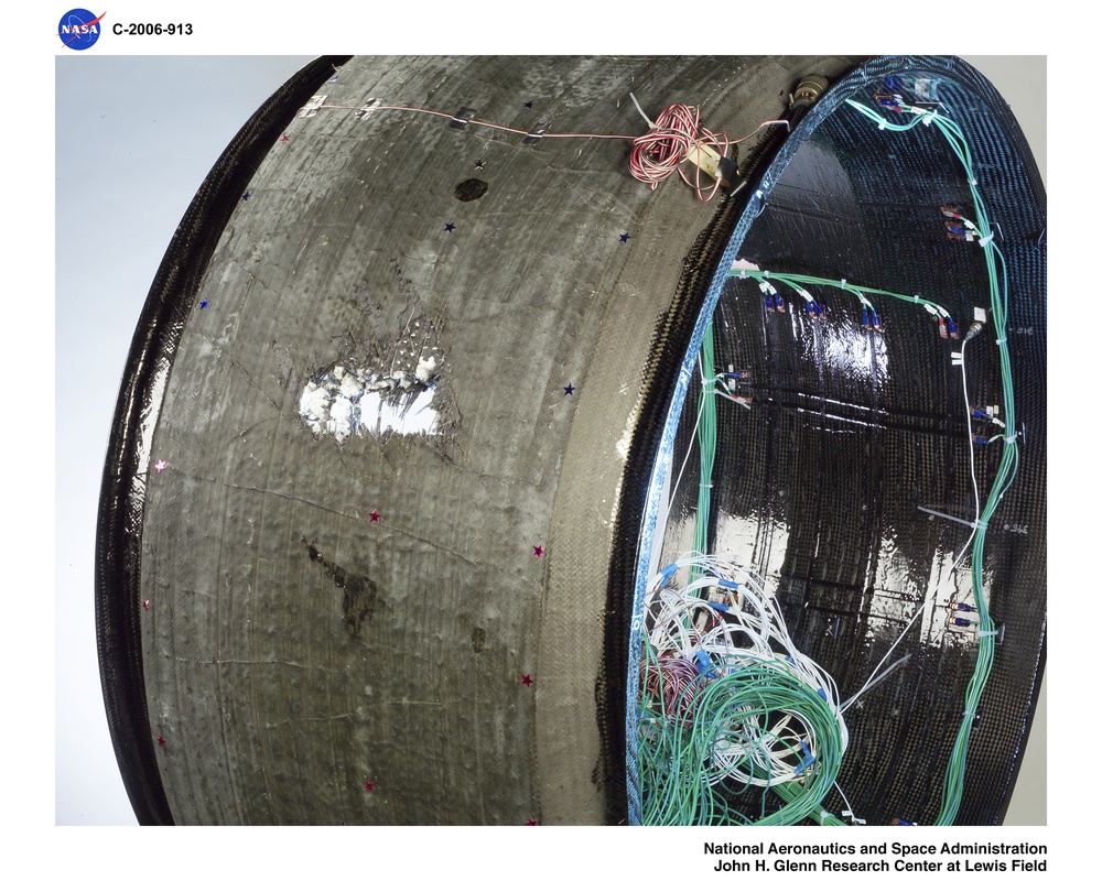 Fan Containment Ring with instrumentation.  Post test photos showing ballistic impact testing results