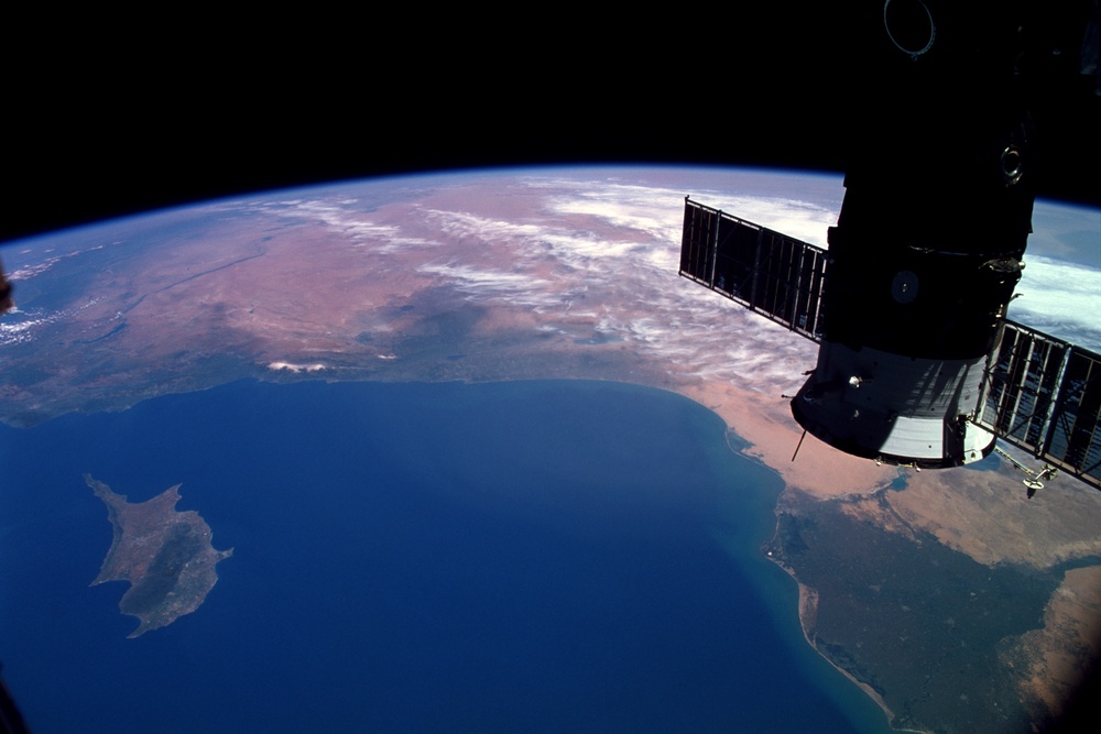 View of Soyuz with Earth view in the background taken during Expedition Six on the ISS