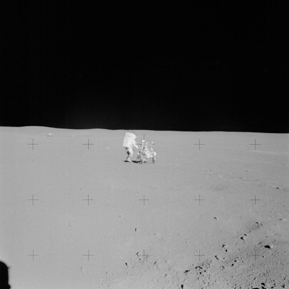 Apollo 14 Mission image - View of Astronaut Mitchell and the Modular Equipment Transporter with the Lunar Module in background.
