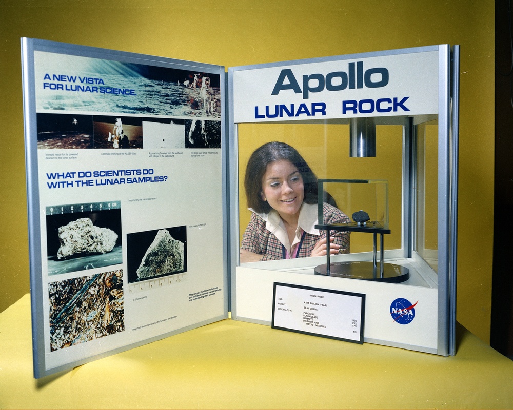 MISS NASA LEWIS MERRI C FAHNENBRUCK WITH APOLLO LUNAR ROCK DISPLAY