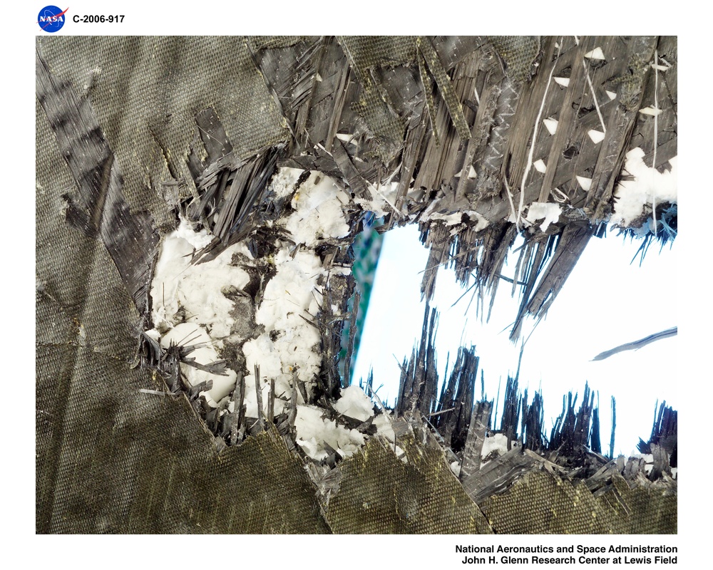 Fan Containment Ring with instrumentation.  Post test photos showing ballistic impact testing results
