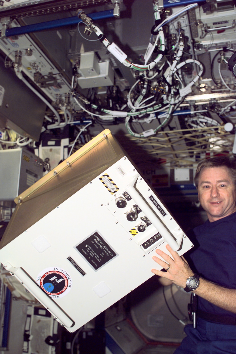 Culbertson poses with MAMS hardware in the U.S. Laboratory during Expedition Three