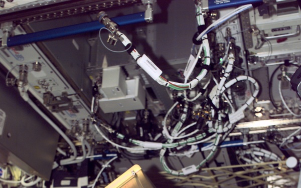 Culbertson poses with MAMS hardware in the U.S. Laboratory during Expedition Three