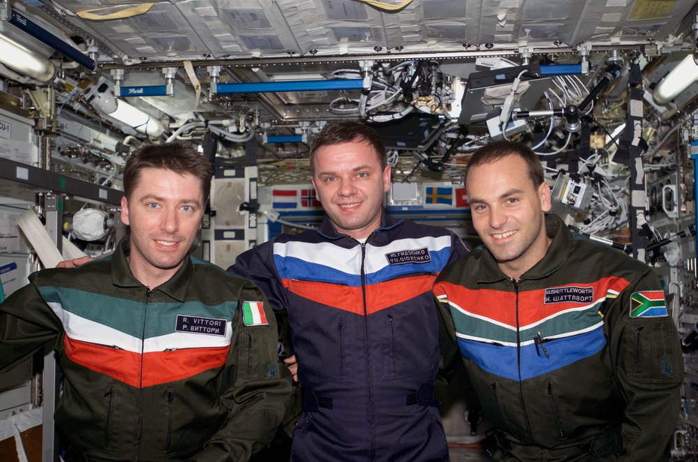 Soyuz 4 taxi-3 flight crew poses for group photo in U.S. Lab during Expedition Four