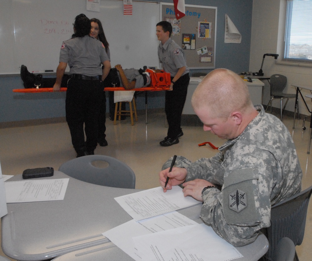 Members of the 81st Civil Affairs Battalion help teach EMT skills to high school students