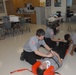 Members of the 81st Civil Affairs Battalion help teach EMT skills to high school students