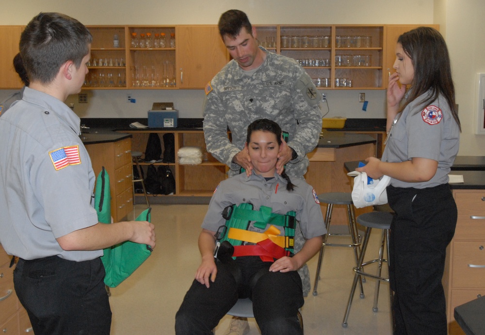 Members of the 81st Civil Affairs Battalion help teach EMT skills to high school students
