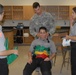 Members of the 81st Civil Affairs Battalion help teach EMT skills to high school students
