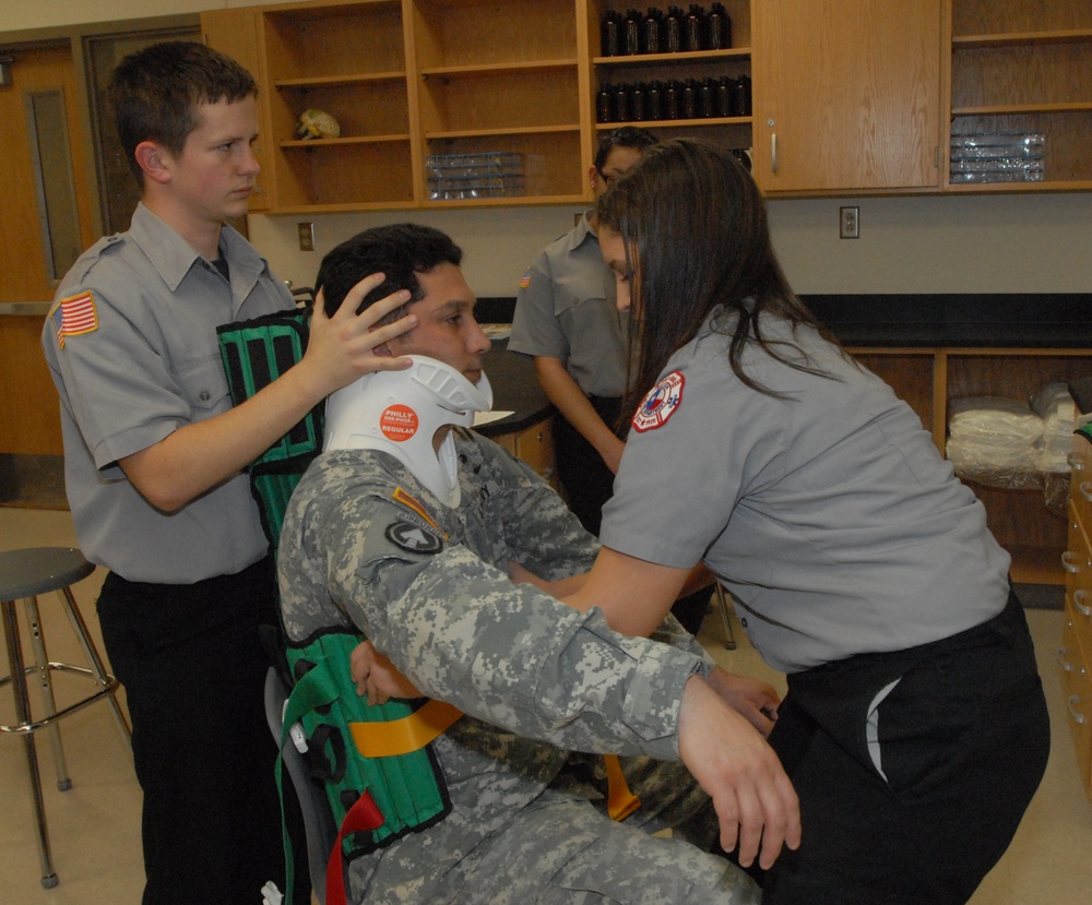 Members of the 81st Civil Affairs Battalion help teach EMT skills to high school students