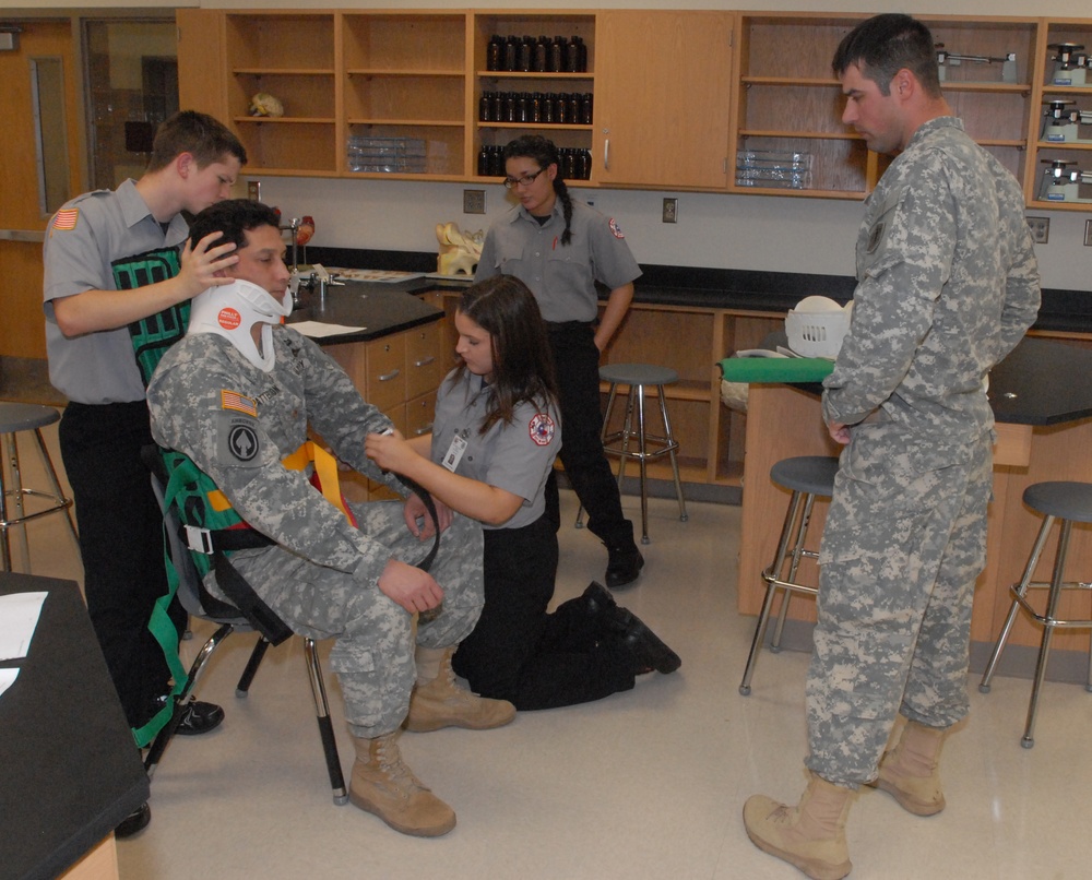 Members of the 81st Civil Affairs Battalion help teach EMT skills to high school students