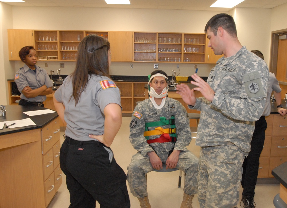 Members of the 81st Civil Affairs Battalion help teach EMT skills to high school students