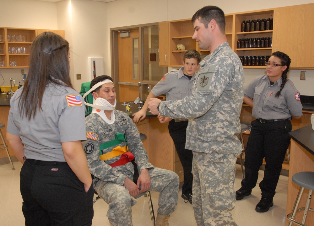 Members of the 81st Civil Affairs Battalion help teach EMT skills to high school students
