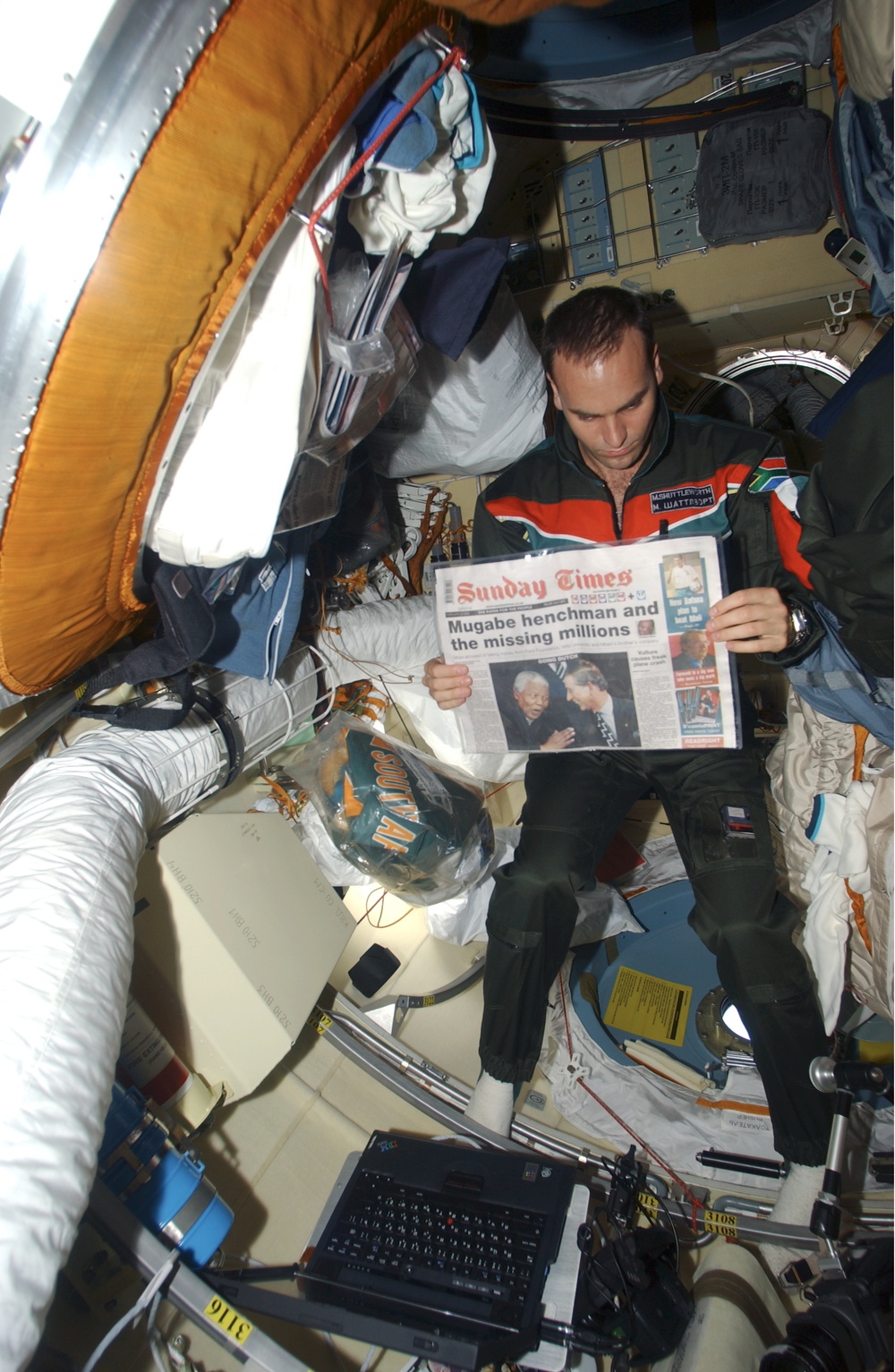 Shuttleworth reads a newspaper in the Pirs during Expedition Four